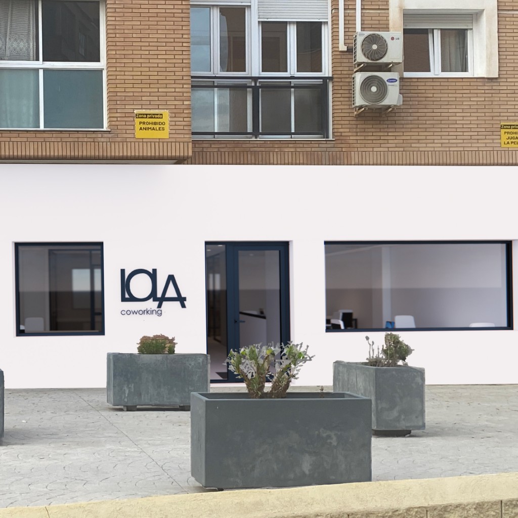Primer plano de la fachada de Lola Coworking en Calle Lima, con puerta y logotipo visibles